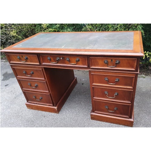 1149 - A 20thC mahogany veneered kneehole pedestal desk with tooled leather top. 1260 x 650 x 770cm h.