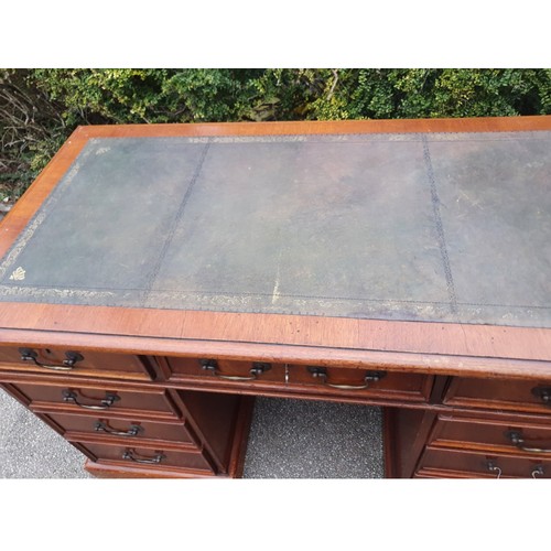 1149 - A 20thC mahogany veneered kneehole pedestal desk with tooled leather top. 1260 x 650 x 770cm h.