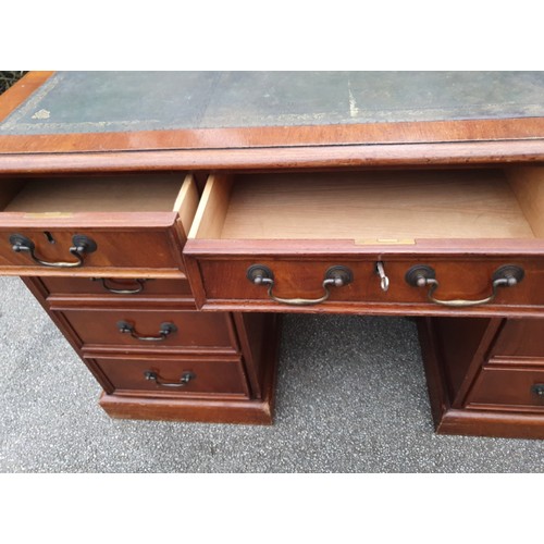 1149 - A 20thC mahogany veneered kneehole pedestal desk with tooled leather top. 1260 x 650 x 770cm h.