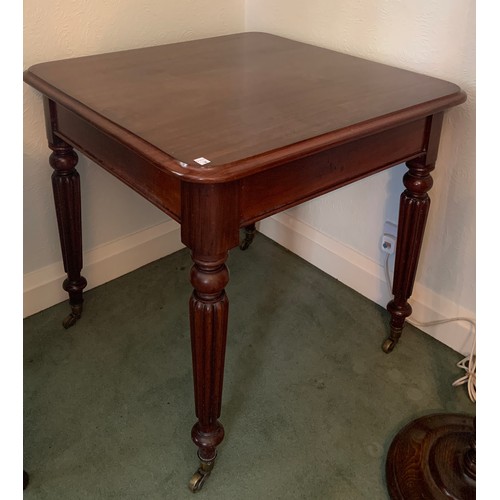 1167 - A square mahogany side table on reeded legs and brass castors. 77 x 77 x 75cm h.