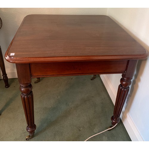 1167 - A square mahogany side table on reeded legs and brass castors. 77 x 77 x 75cm h.