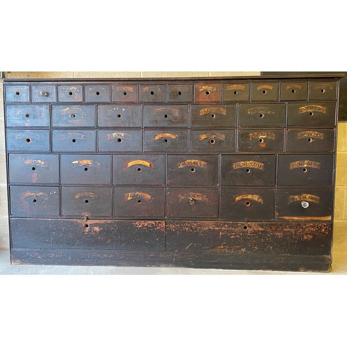 1178 - A 19thC pine 38 drawer drug run/chest with gilt and black labels and glass knobs to all drawers. 193... 