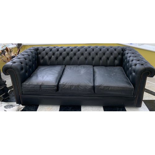 1172 - A pair of black leather button backed Chesterfield sofas. 190 l x 65 h x 87 d.