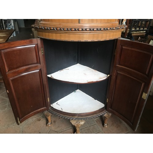 1174 - Walnut bow front corner cabinet, 2 glazed door top, 2 door base, claw and ball feet.