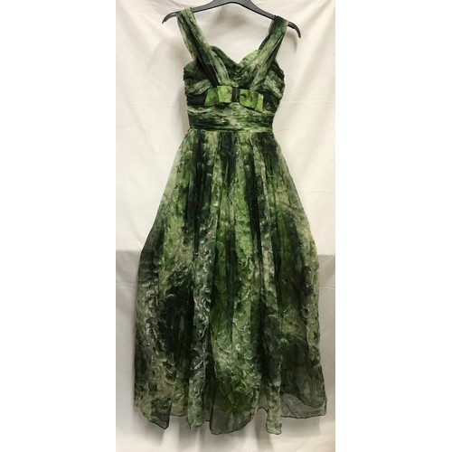 507 - A 1950's Marjon Couture evening dress in green shades with mesh outer layer, gathered waist and bow ... 