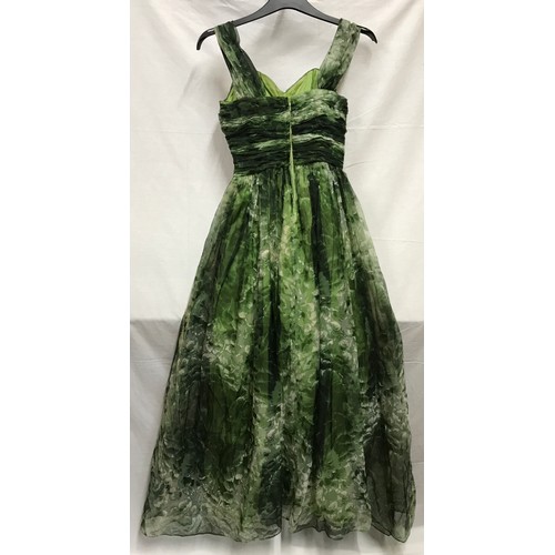 507 - A 1950's Marjon Couture evening dress in green shades with mesh outer layer, gathered waist and bow ... 