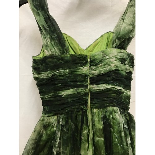 507 - A 1950's Marjon Couture evening dress in green shades with mesh outer layer, gathered waist and bow ... 