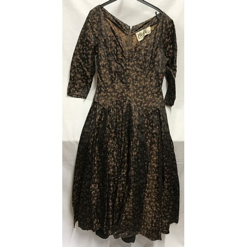 508 - A 1950's cocktail dress by Chatil,  black and brown silk style fabric with collared hips, v- neck, 3... 