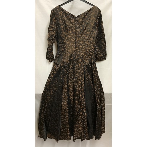 508 - A 1950's cocktail dress by Chatil,  black and brown silk style fabric with collared hips, v- neck, 3... 