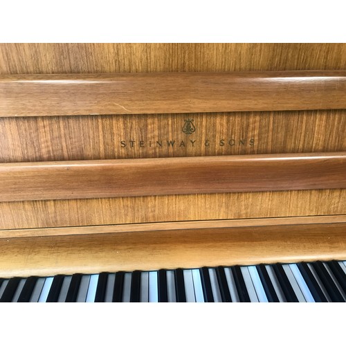 790 - A Steinway and Sons upright piano 146 w x 59 d x 114cm h and a piano stool and contents.