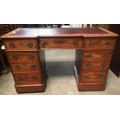 A Victorian mahogany kneehole pedestal desk with 9 drawers and brass handles and red rexine inlay to... 