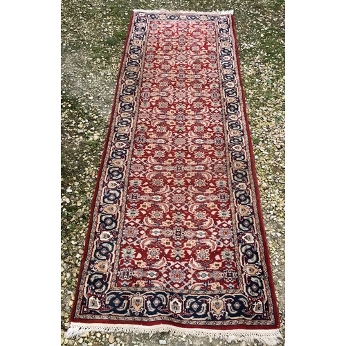 514 - Red ground wool floral pattern runner rug 270cm l x 81cm w.