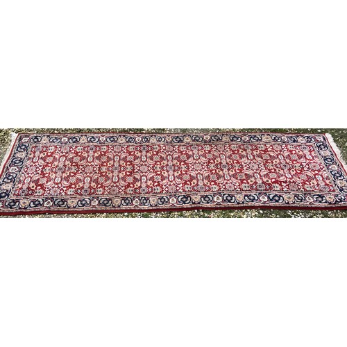 514 - Red ground wool floral pattern runner rug 270cm l x 81cm w.