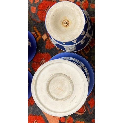 157 - A quantity of blue Wedgwood to include two twin handled vases, 20cms high, a planter 18.5 diameter, ... 