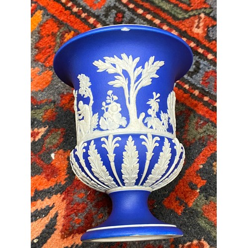 157 - A quantity of blue Wedgwood to include two twin handled vases, 20cms high, a planter 18.5 diameter, ... 