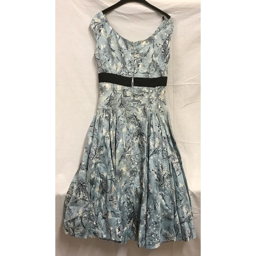 465 - A 1950's ladies dress, handmade, light blue with black bow and fitted underskirt approx. size 26 inc... 