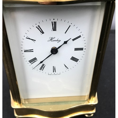 799 - A Henley brass carriage clock with original key case. 16cm h with handle x 8.5cm w x 7cm d.