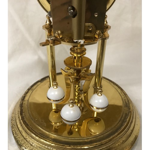 800 - A Kundo German brass dome glass cased anniversary clock with key, roman numerals, 400 day.