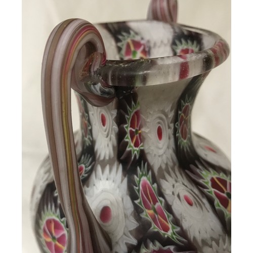 287 - A decorative coloured glass vase with twin handles. Multicoloured, pontil to the base. 16.5cm h x 9c... 