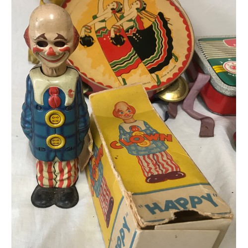 665 - A tinplate toys collection to include: German U.S. Zone Happy clown, Chad Valley Treasure Island boo... 