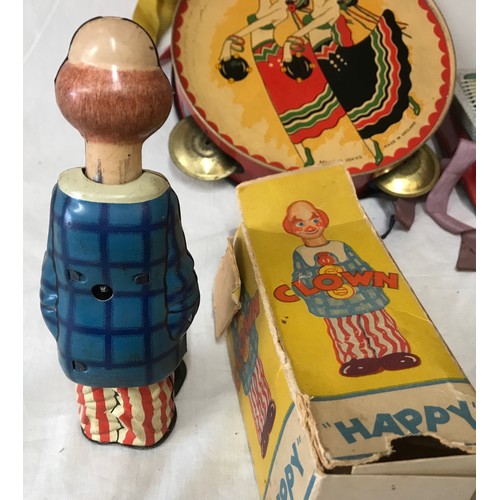 665 - A tinplate toys collection to include: German U.S. Zone Happy clown, Chad Valley Treasure Island boo... 