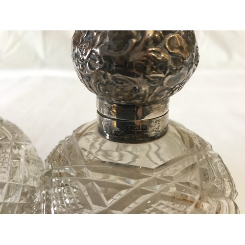 530 - Two silver topped cut glass scent bottles with floral pattern to silver, Birmingham 1909 and spheric... 