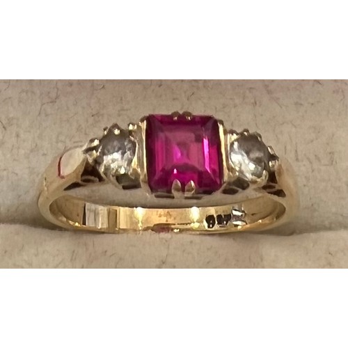 343 - A 9 ct gold ring with central pink stone flanked by 2 diamonds. Size N. 2.3gms.