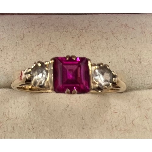 343 - A 9 ct gold ring with central pink stone flanked by 2 diamonds. Size N. 2.3gms.