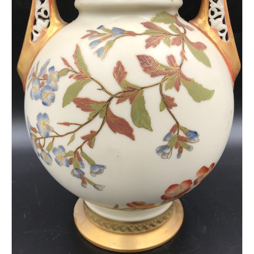 10 - A Royal Worcester lidded vase with floral decoration and pierced dragon headed handles. 41cms.