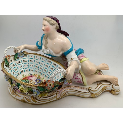 11 - A John Bevington figural sweetmeat basket modelled as a classical lady seated by a shell shaped oval... 