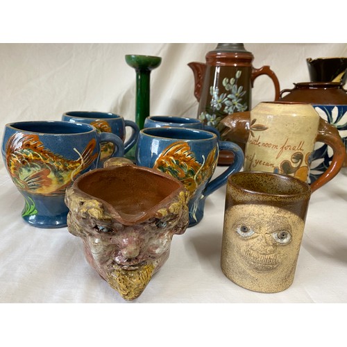 14 - A large collection of Studio pottery to include : C H Brannam Barum mottoware fish jug, dated 1891, ... 