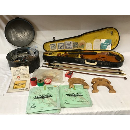 766 - Violin (in need of restoration) and case along with a round tin. Round tin contains spares for both ... 