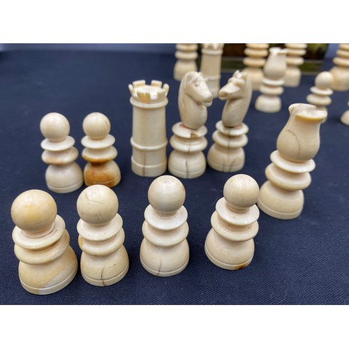 671 - A complete 19thC bone chess set in a metal box.