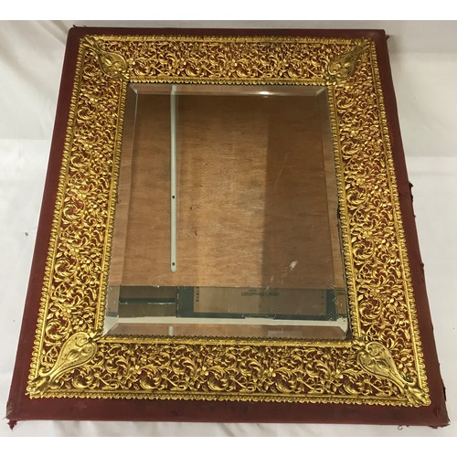 1351 - Cloth bound, wood and decorative brass framed bevelled edged wall mirror. Frame size 57cms h x 50cms... 