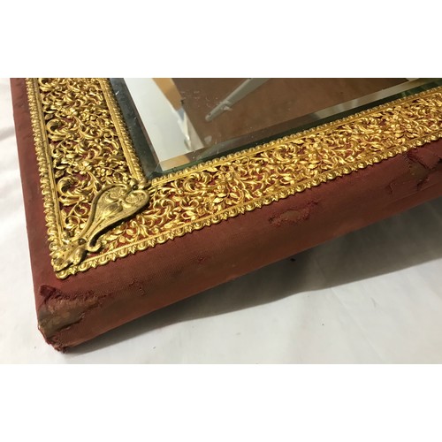 1351 - Cloth bound, wood and decorative brass framed bevelled edged wall mirror. Frame size 57cms h x 50cms... 