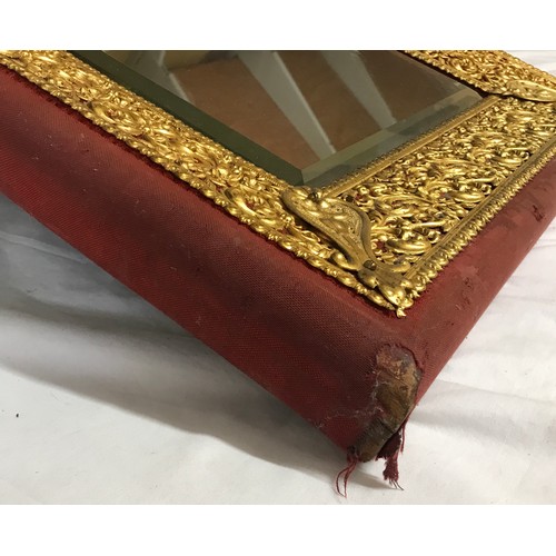 1351 - Cloth bound, wood and decorative brass framed bevelled edged wall mirror. Frame size 57cms h x 50cms... 