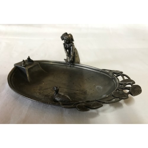 24 - A WMF dish depicting a lady releasing a duck into a pond. 15 l x 9.5cm w.
