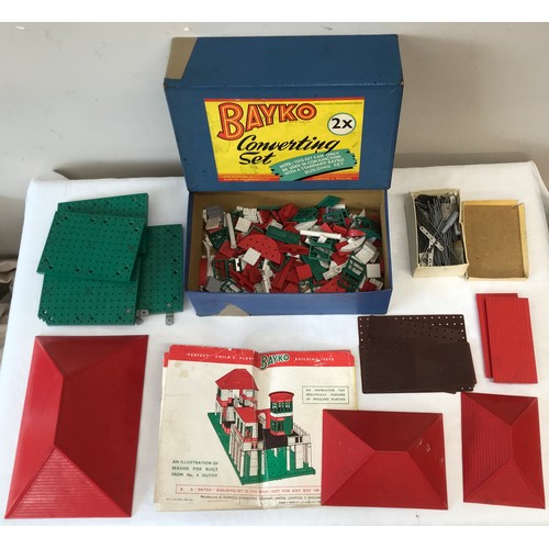 676 - Bayko boxed converting building set 1 and 2 with instructions for multiple structures.