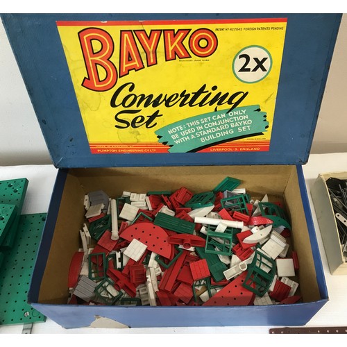 676 - Bayko boxed converting building set 1 and 2 with instructions for multiple structures.