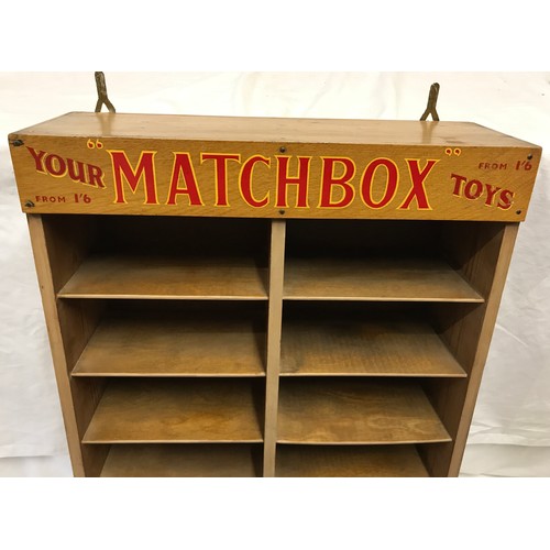 678 - Matchbox Toys wall mounted display shelf, pine cased, 6 height with Matchbox advertising panel. 12 s... 