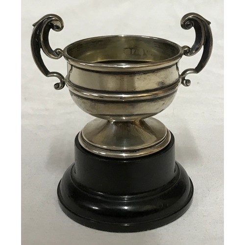 542 - A small silver trophy with black plastic base, Birmingham 1936 measures 5.5cms h x 8cms w and total ... 