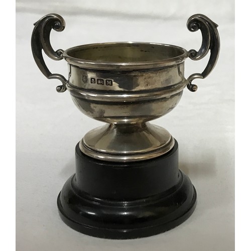 542 - A small silver trophy with black plastic base, Birmingham 1936 measures 5.5cms h x 8cms w and total ... 