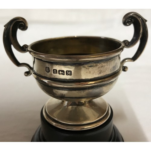 542 - A small silver trophy with black plastic base, Birmingham 1936 measures 5.5cms h x 8cms w and total ... 