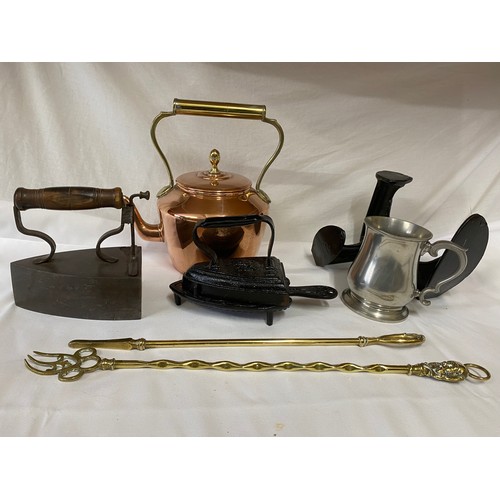 627 - Two cast flat irons, a copper kettle 27cm h, brass poker and fork, cast pewter tankard and a cast ir... 