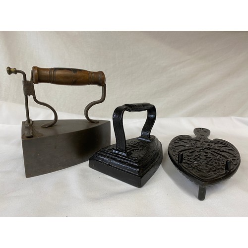 627 - Two cast flat irons, a copper kettle 27cm h, brass poker and fork, cast pewter tankard and a cast ir... 