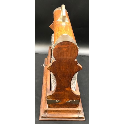 303 - Oak cased, brass mounted three bottle tantalus with key, 36cm h to handle, base 39 w x 17cm d.