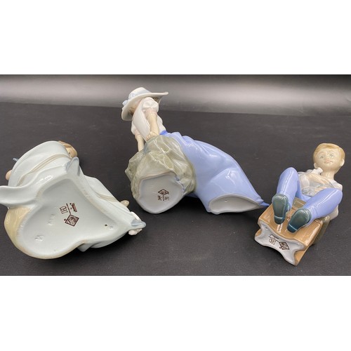 70 - Five various Lladro Nao figurines. Tallest seated girl with 2 puppies 18cm h.