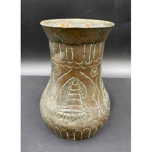 796 - Middle Eastern hand beaten silvered copper drinking vessel of crude design.