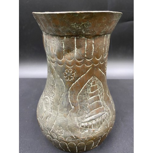 796 - Middle Eastern hand beaten silvered copper drinking vessel of crude design.