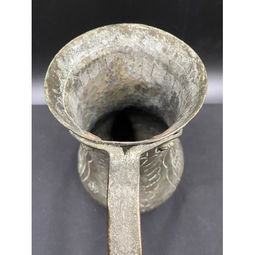 796 - Middle Eastern hand beaten silvered copper drinking vessel of crude design.